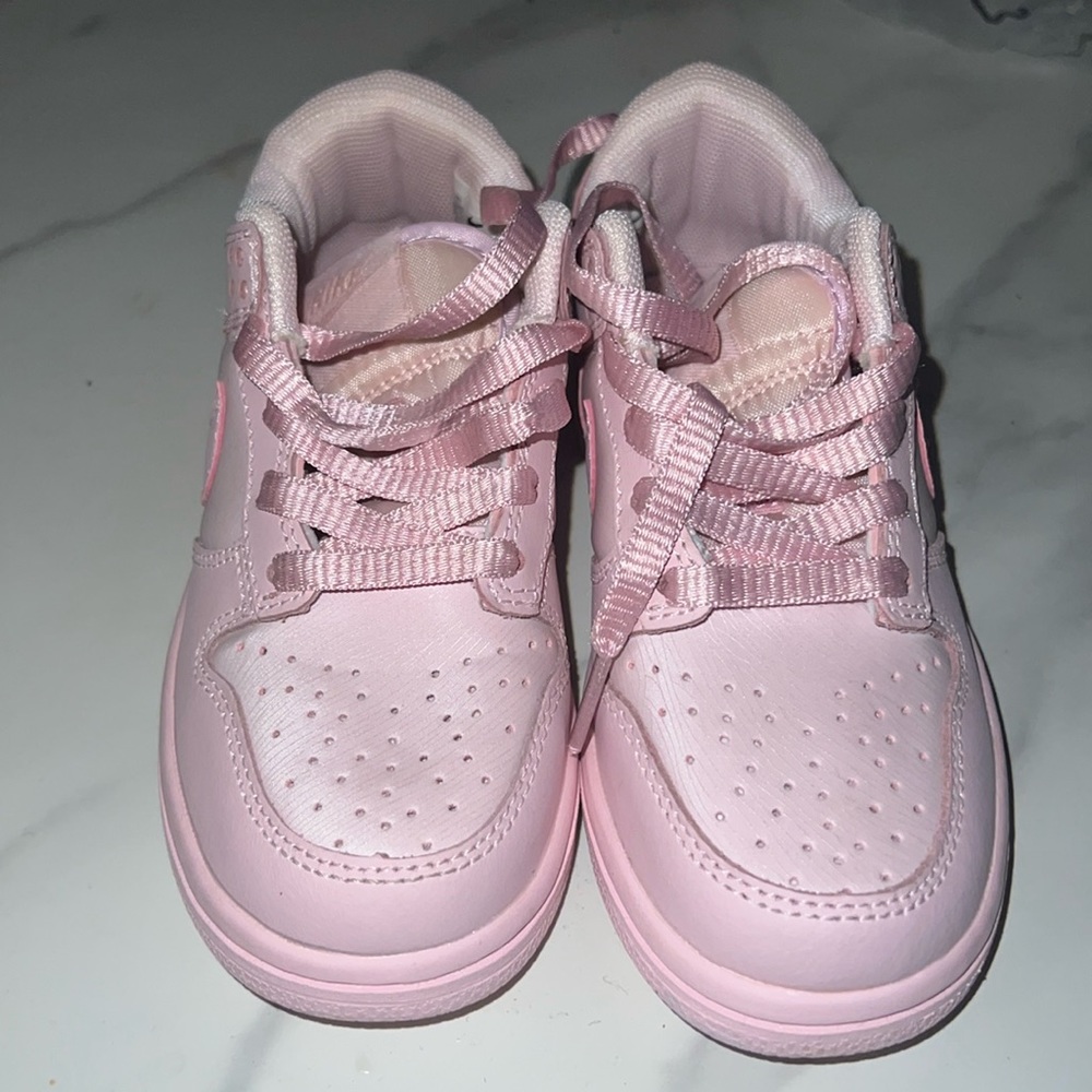 Brand new pink Nike low dunks. No box but can ship with Nike plastic bag